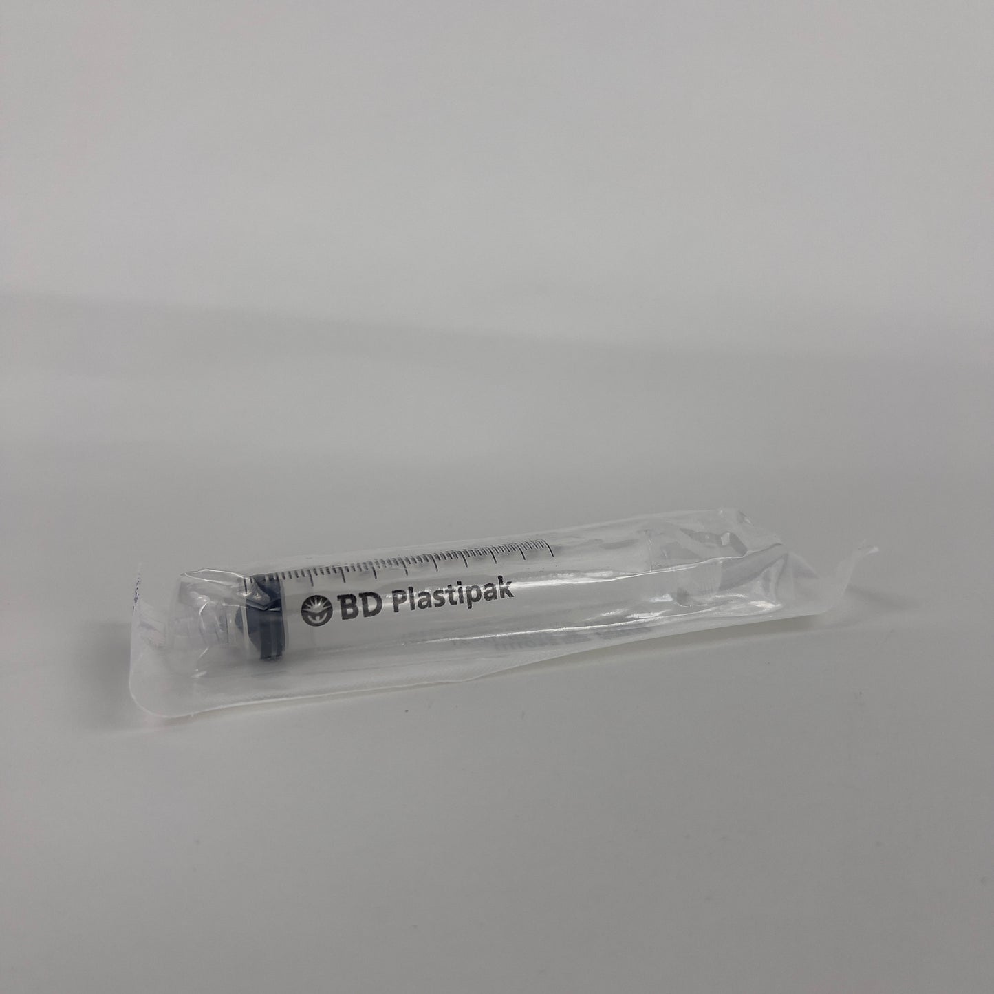 a sterile luer lock syringe in wrapping