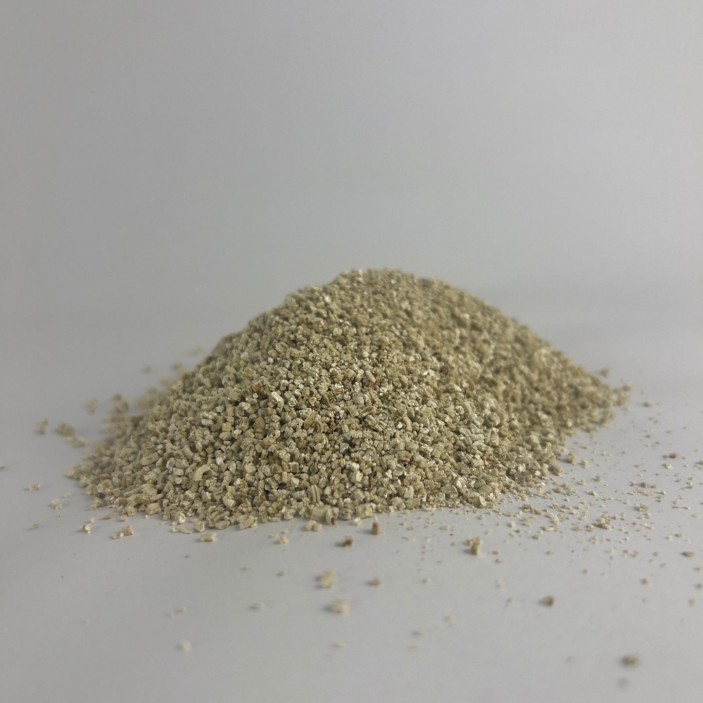 A pile of fine-grade vermiculite, commonly used as a soil or mushroom substrate additive.