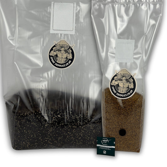 Two clear plastic grow bags filled with substrate, one black and one brown, with a small branded card in front, photographed on a white background.