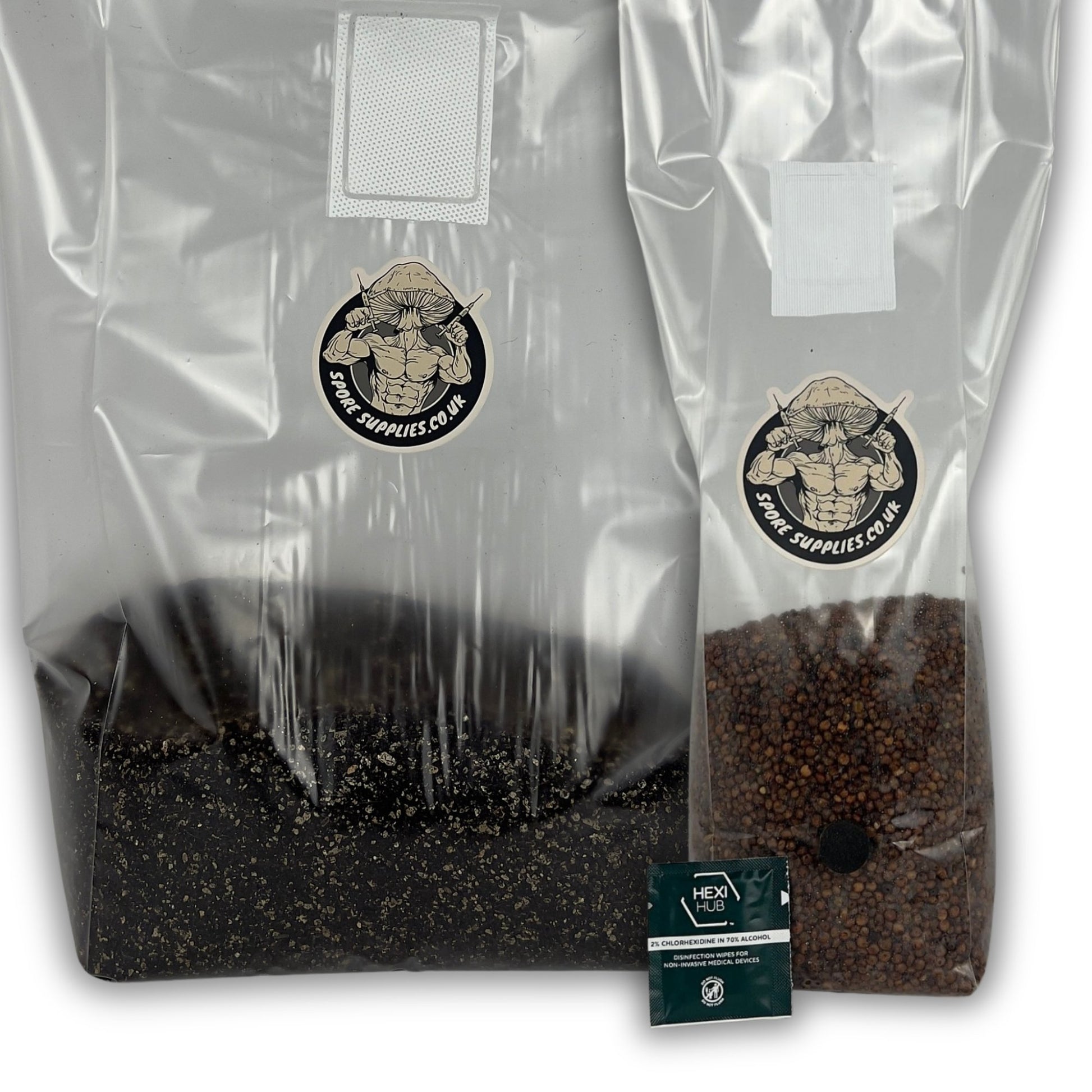 Two clear plastic grow bags filled with dark substrate, shown on a white background. One large bag contains black substrate and one smaller bag contains brown milo grain.