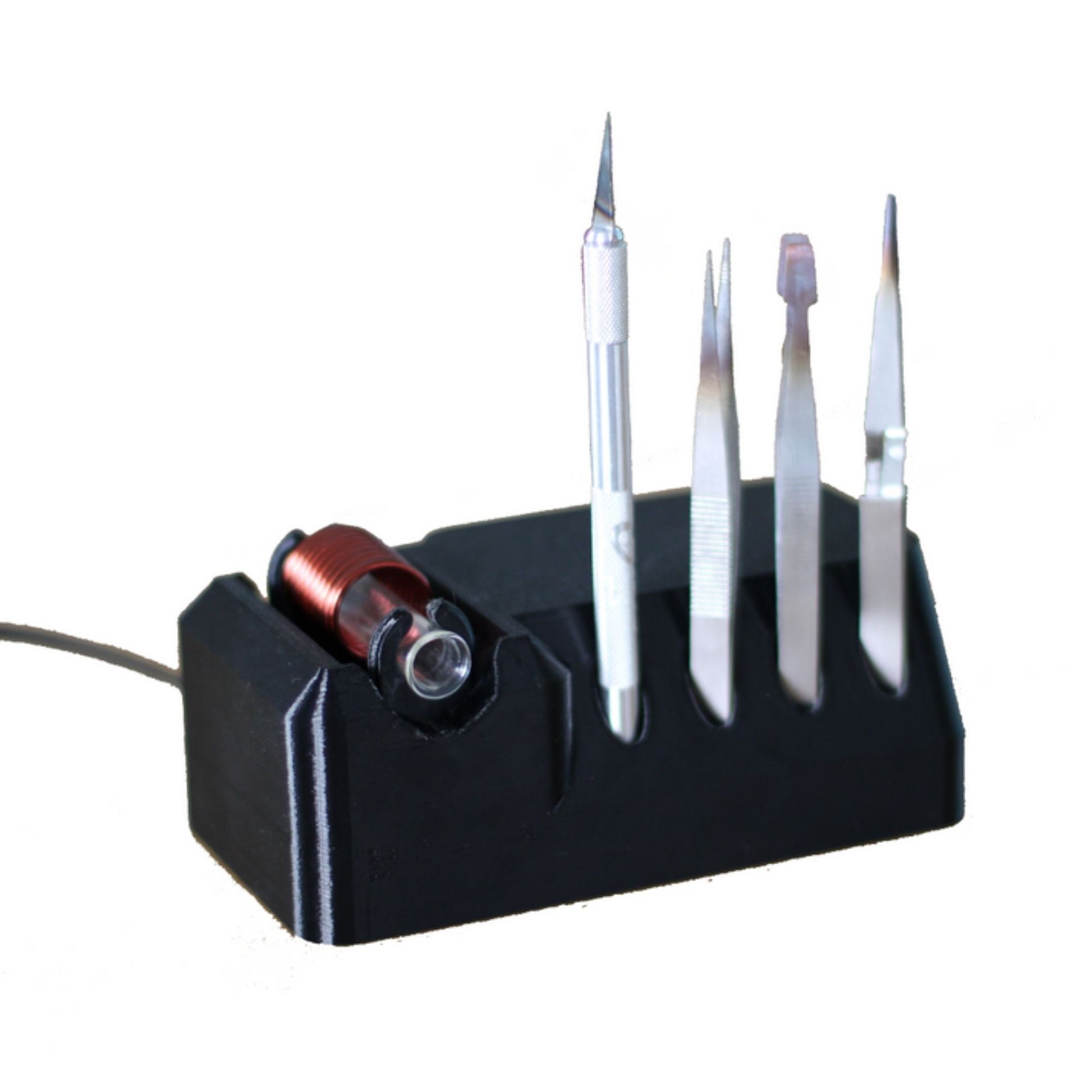 A black induction steriliser with a borosilicate glass coil shield, equipped with storage space for up to four tools, and a power supply attached to the side.