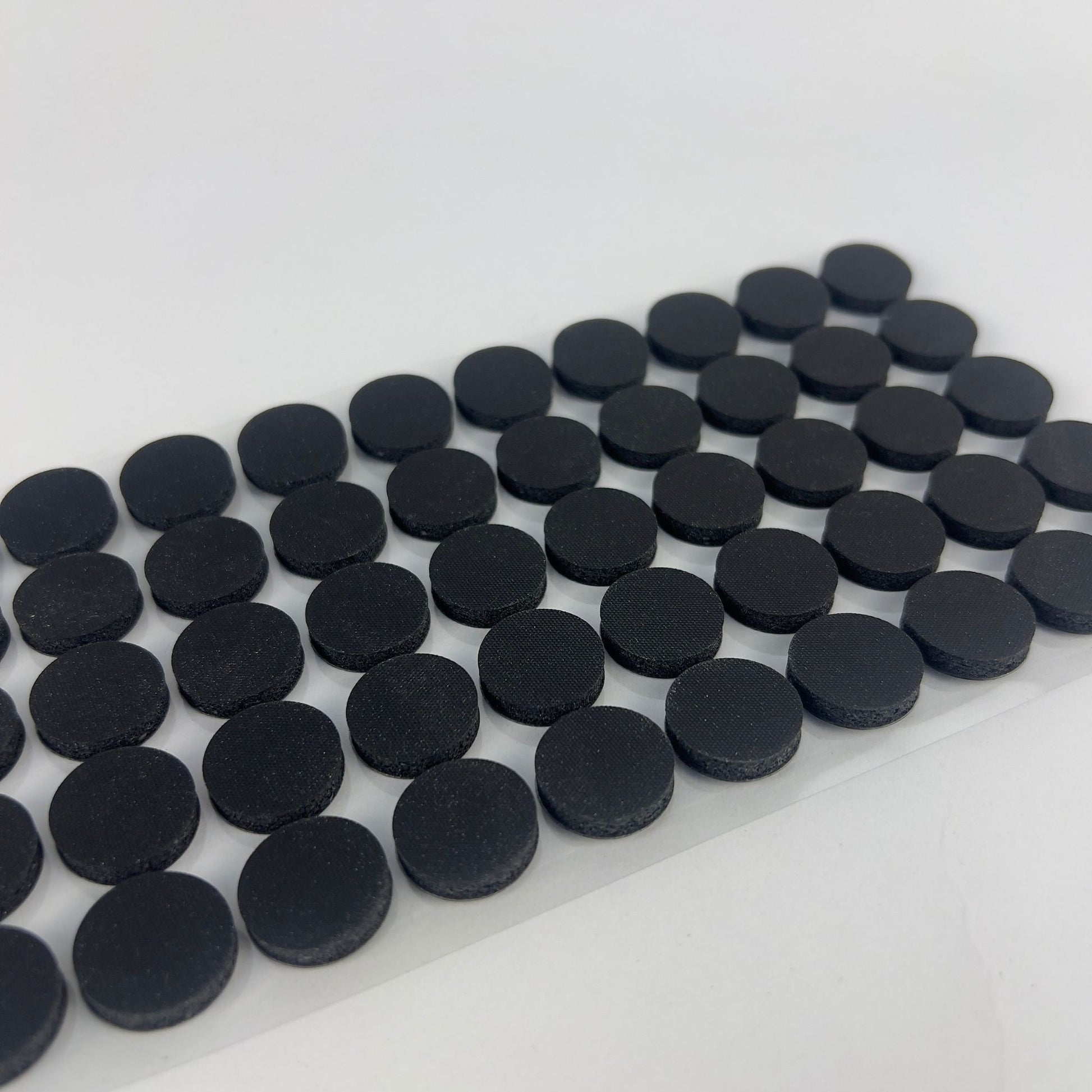 50 x black self-healing injection ports on a sticky sheet