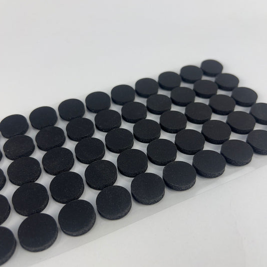 50 x black self-healing injection ports on a sticky sheet